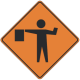 A flagger is stationed ahead to control road users.